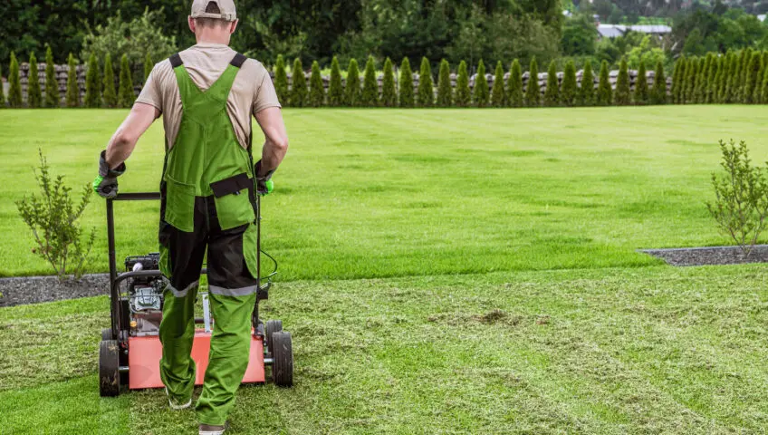 Man aerating lawn