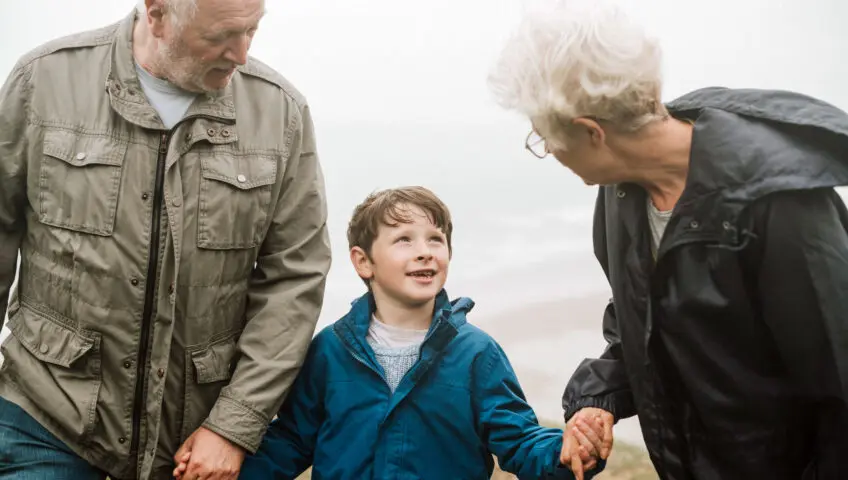 Grandparents walking with their grandson