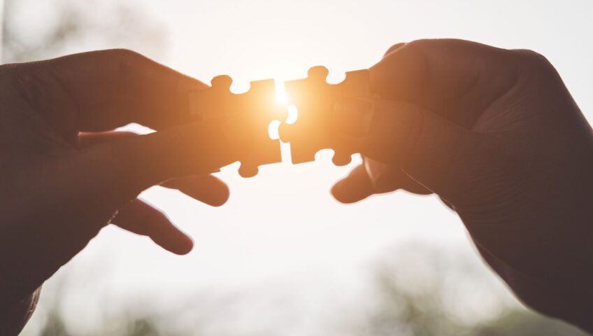 Hands with puzzle pieces