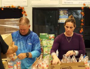 Slug-A-Bug volunteers stocking backpacks